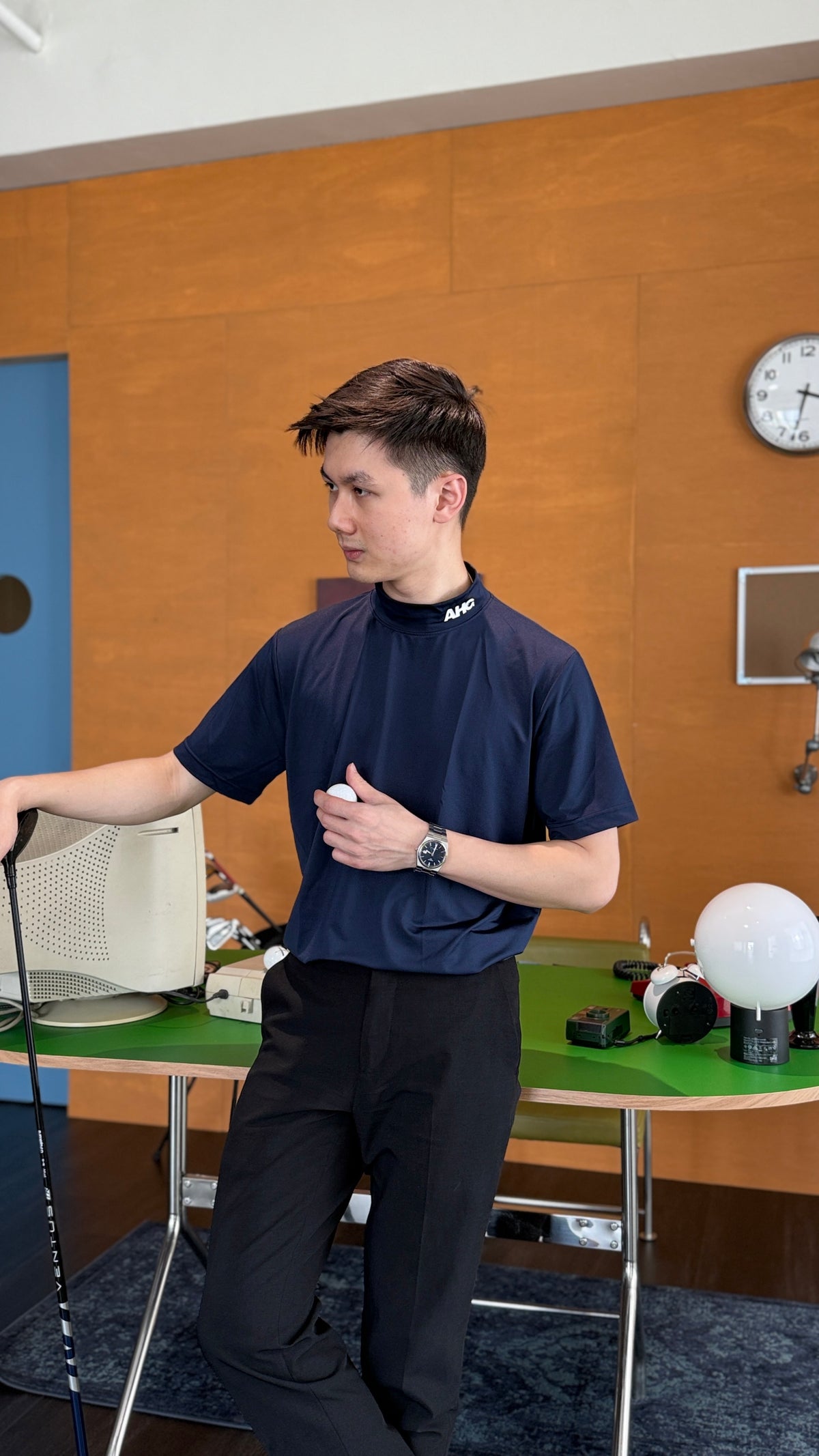 Alderhall Golf Midnight Mock Neck Worn by Model Facing Left Side in Office 