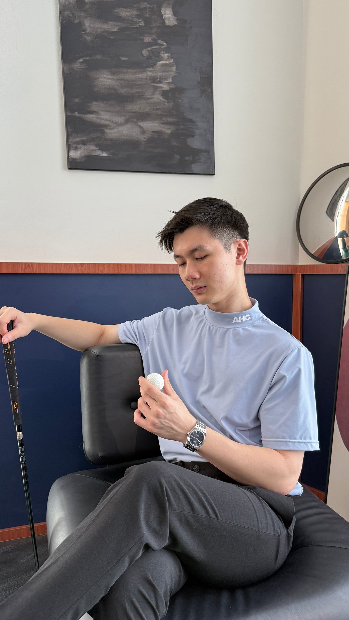 Alderhall Golf Sky Mock Neck Shirt Worn by Model While Sitting on Sofa 